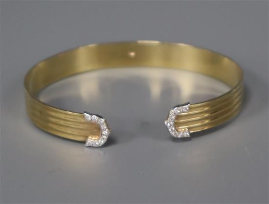 A 9ct. gold and diamond set open bangle.